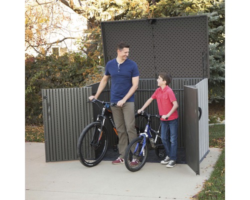 Fietsbox met twee fietsen en twee personen in de tuin.