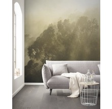Woonkamer met fotobehang van een bos in de mist, bank en bijzettafel.