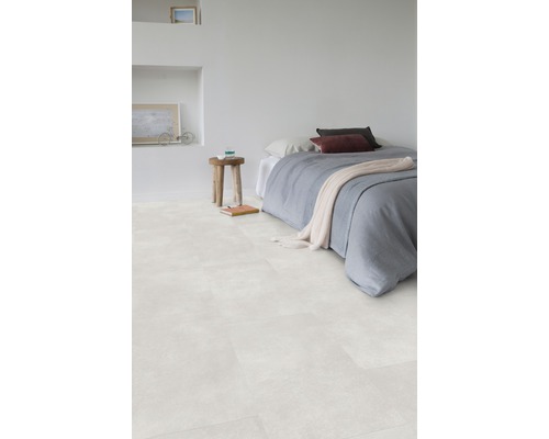 Slaapkamer met lichte vloerbedekking, bed en houten kruk