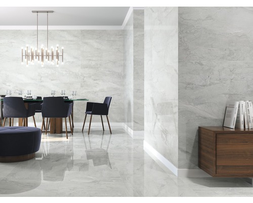 Lichte ruimte met eettafel en wand- en vloertegels in marmerlook