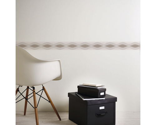 Kameropstelling met decoratieve rand aan de muur, een stoel en opbergdozen