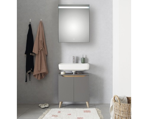 Moderne badkamer met wastafelonderkast, opzetwastafel en verlichte spiegelkast.