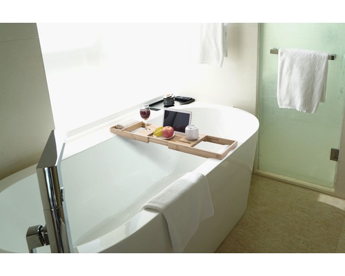 Badkamer met bad en bamboe badplank met drankje, tablet en fruit