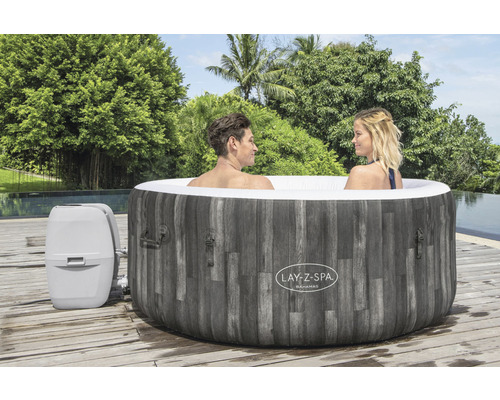 Opblaasbare Lay-Z-Spa Bahamas met twee personen en pomp op een houten terras
