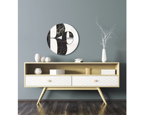 Decoratieve wanddecoratie met ronde afbeelding en opschrift boven dressoir