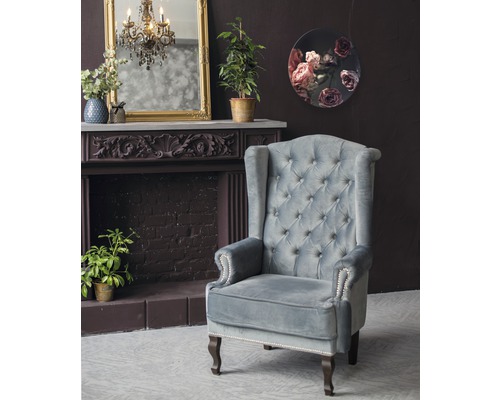 Interieurweergave met oorfauteuil, open haard en decoratie