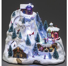 Decoratief geanimeerd winterlandschap met huizen, bomen, figuren en een trein