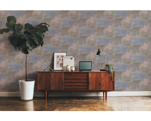 Woonkamer met behangpatroon, dressoir, kamerplant en decoratie