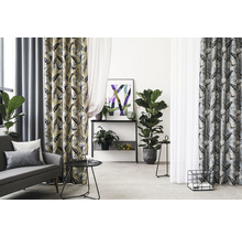 Woonkamer met bank, tafel en gordijnen met print