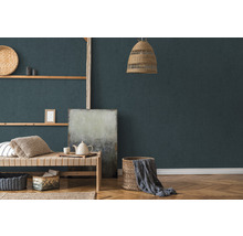 Woonkamer met hanglamp van rotan, wandplanken, daybed en manden