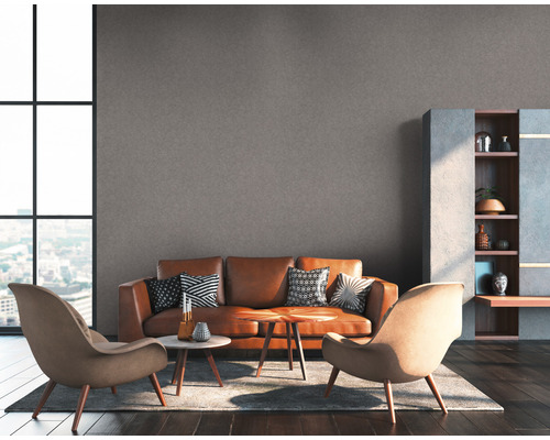 Woonkamer met bank, fauteuils en rekken