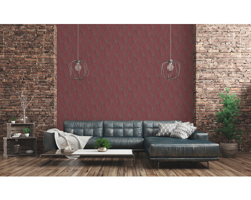 Woonkamer met bakstenen muur, rood patroonbehang en grijze bank