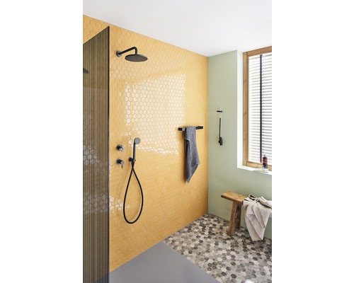 Badkamer met douche, kranen en zeshoekige tegels op wand en vloer