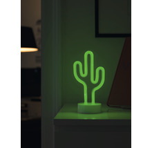 Decoratieve cactus tafellamp van neon op een nachtkastje