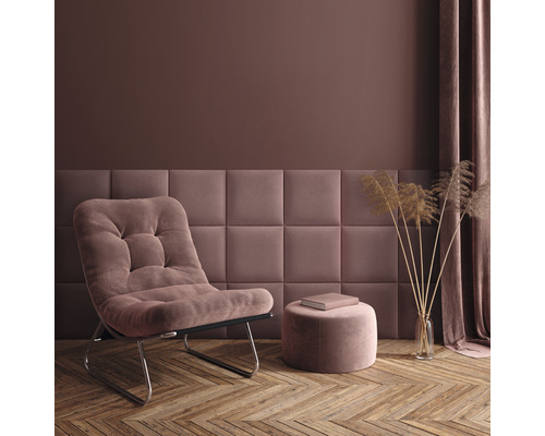 Woonkamer met fauteuil, kruk, wandpanelen en decoraties op houten vloer