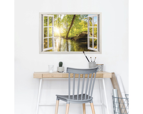 Muursticker met venstermotief en uitzicht op een rivier in de natuur boven een bureau