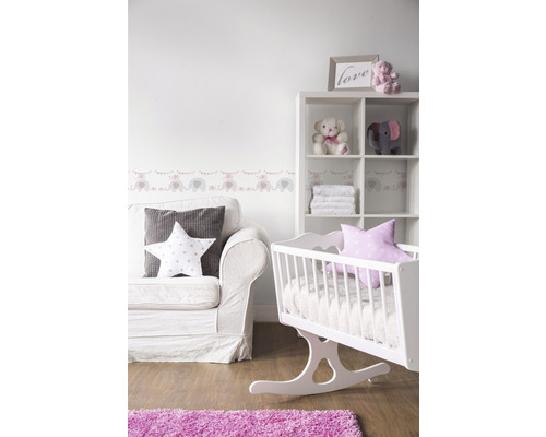 Babykamer met schommelwieg, bank, rek en decoraties