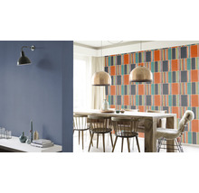 Eetkamer met eettafel, stoelen, wandlamp en behang met patroon