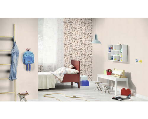 Lichte kinderkamer met bed, bureau, stoel en decoratieve objecten.