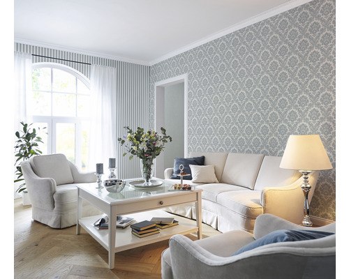 Woonkamer met bank, fauteuil, salontafel en patroonbehang