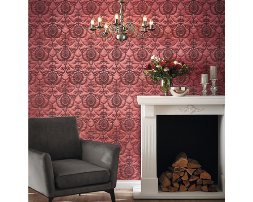 Woonkamer met patroonbehang, fauteuil en open haard