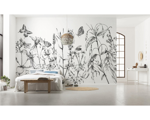 Ruime slaapkamer met fotobehang met bloemen, bed en gevlochten lamp