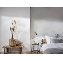 Lichte slaapkamer met houten bed, bedlamp en decoratie op een houten tafel