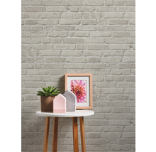 Decoratief bakstenen behang met bijzettafel, plant en fotolijst