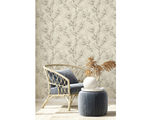 Scene met rotan stoel, kruk en behang met plantenmotief voor een stijlvol interieur