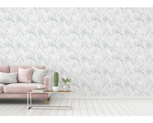 Woonkamer met marmeren behang, bank en tafeldecoratie