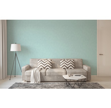 Woonkamer met bank, staande lamp en behang met patroon