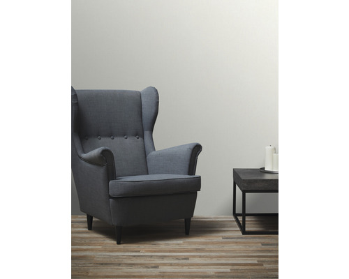 Woonkamer met fauteuil en bijzettafel met kaarsen