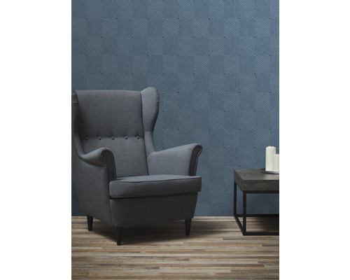 Woonkamer met oorfauteuil, bijzettafel en behang met patroon