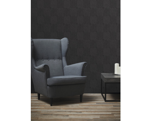 Woonkamer met fauteuil, bijzettafel en geometrisch behang