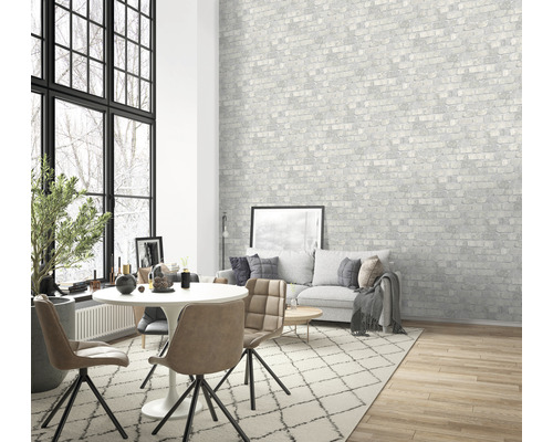 Woonkamer met eettafel, stoelen, bank en bakstenen behang met patroon