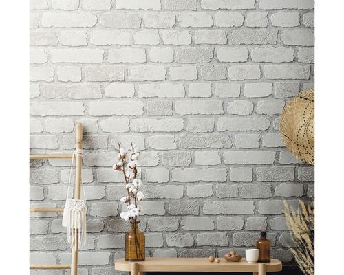 Wanddecoratie met metselwerkmotief behang, houten ladder en decoratie