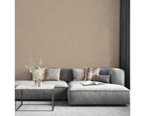 Woonkamer met bank, kussens, tafel en decoratieve muur