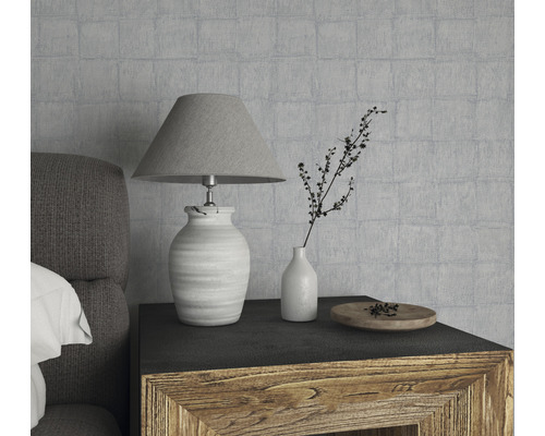 Decoratief stilleven met lamp, vaas en houten schaal op een nachtkastje voor een gestructureerde wand