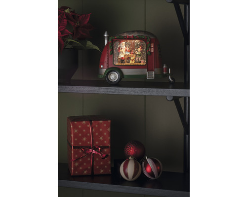 Decoratief object met kersttafereel in de vorm van een caravan met kerstman en elfen op een plank