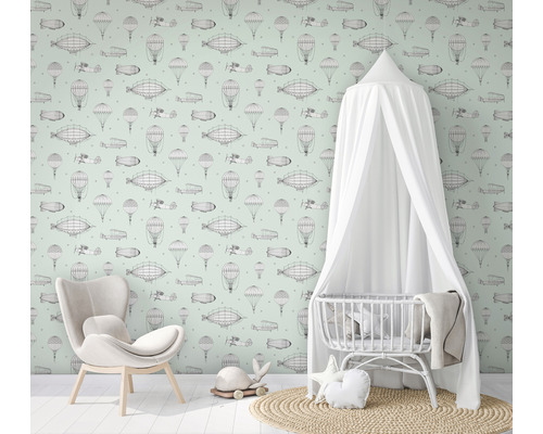 Kinderkamer met luchtvaartbehang, fauteuil en babybed