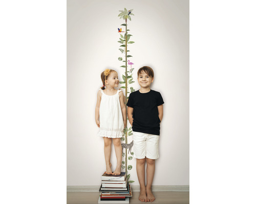 Kinderen staan naast een groeigrafiek met dierenmotieven op een muur