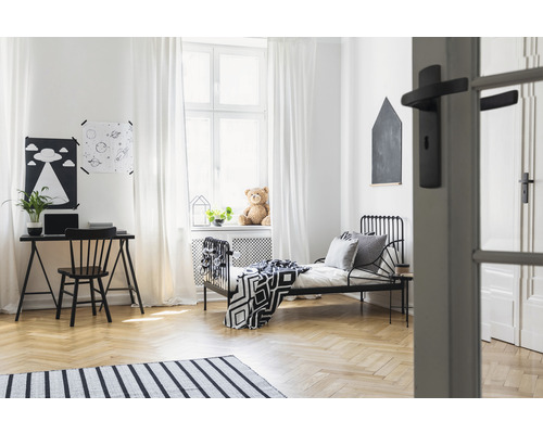 Lichte kinderkamer met bed, bureau en decoratie