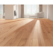 Lichte woonkamer met houten vloer, bank en raam