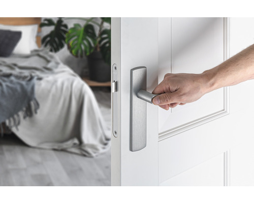 "Een hand opent een deur met een moderne deurklink