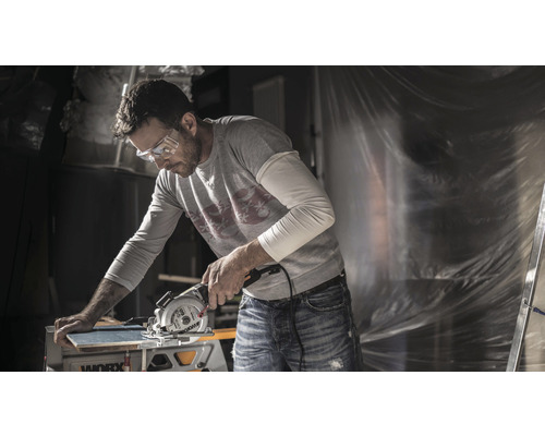 Man met veiligheidsbril snijdt een plank met een Worx cirkelzaag