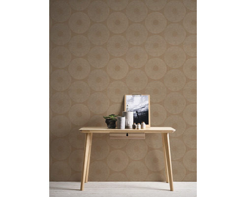 Interieuridee met bruin behang met cirkelpatroon, een tafel met decoraties en een fotolijst.