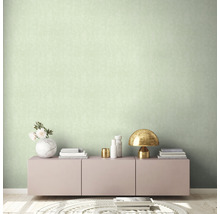 Lichte kamer met een patroonbehang, een dressoir en decoraties.