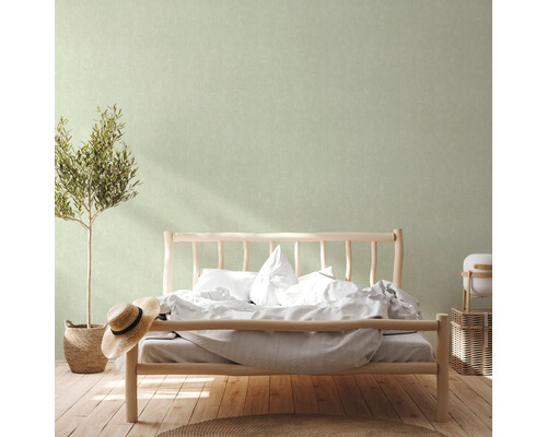 Slaapkamer met houten bed, plant, hoed en decoratieve wand