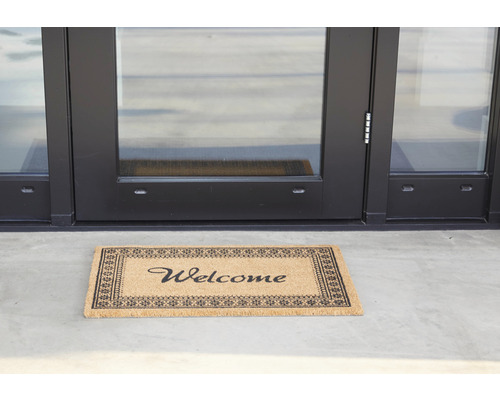 Deurmat met de tekst Welkom voor een deur
