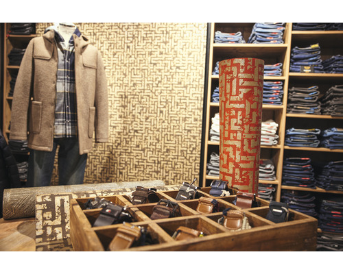 Interieurbeeld van een kledingwinkel met jas, jeans en riemen